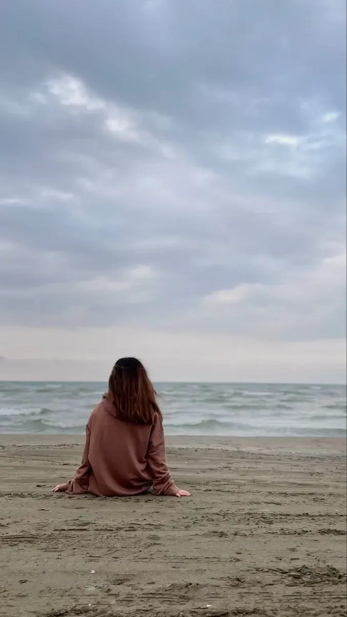 ایده عکاسی بدون چهره نشسته روی ساحل